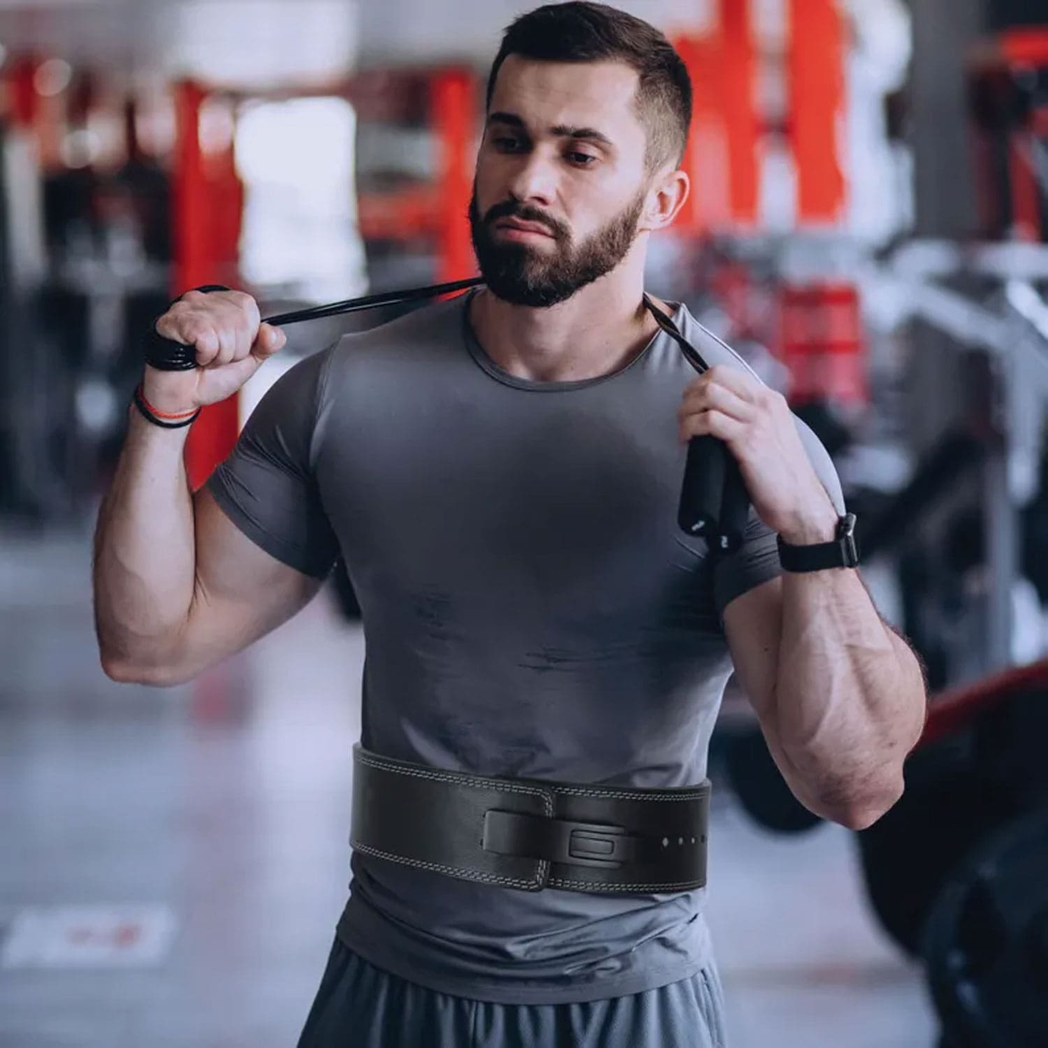 Model using the custom gym belt while performing deadlifts in a gym setting, demonstrating secure core support, adjustable fit, and functional athletic use.