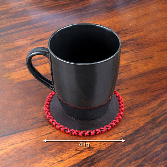 Leather coasters placed beneath coffee mugs and whiskey glasses on a wooden bar counter, highlighting their stylish utility and handmade charm in a real-life setting.

