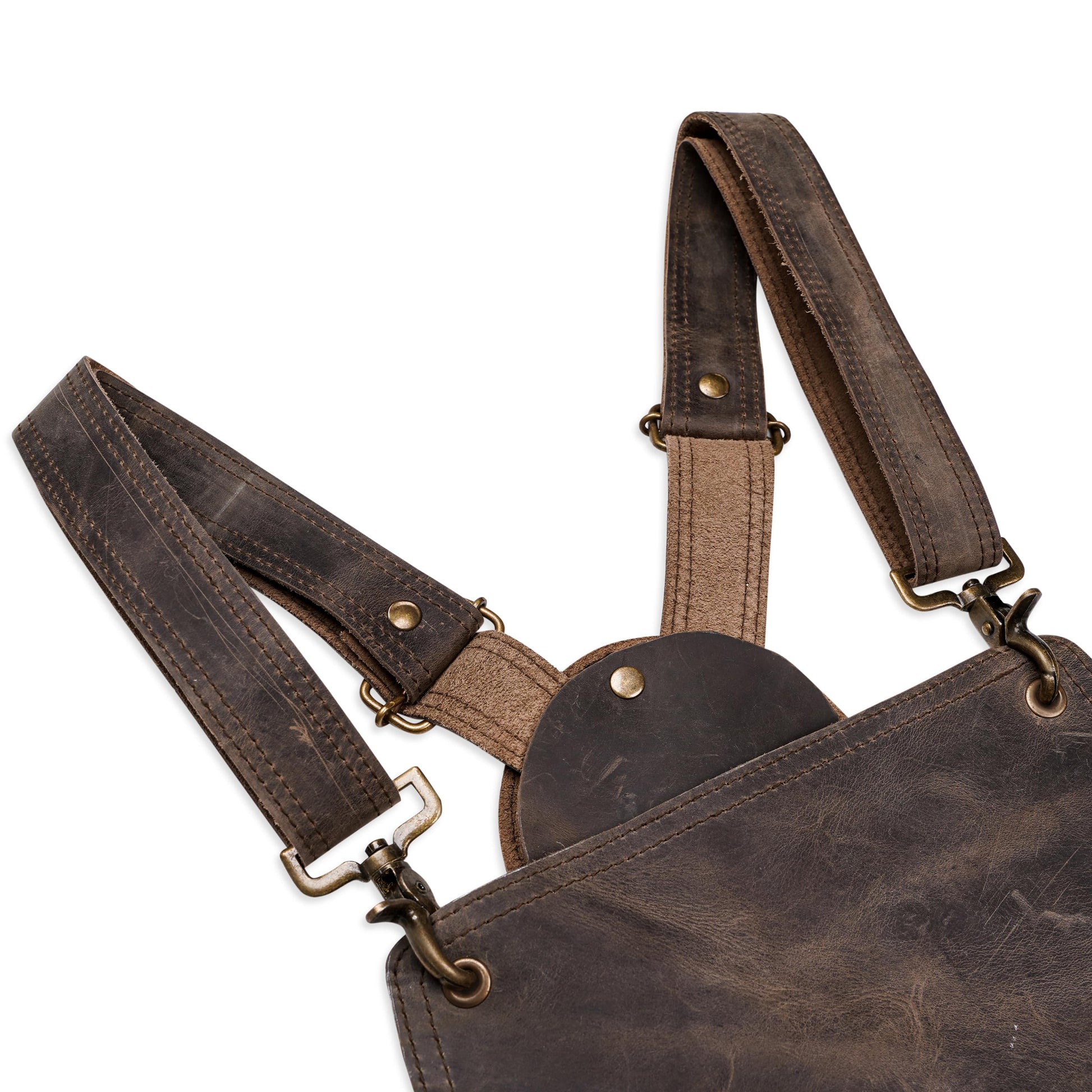 Close-up image of handcrafted pullup leather chef apron, focusing on leather texture, reinforced stitching, and brass buckle detailing. Captures premium craftsmanship, ideal for showcasing personalization area. Great for chefs, BBQ pros, and hairstylists looking for functional and elegant workwear.

