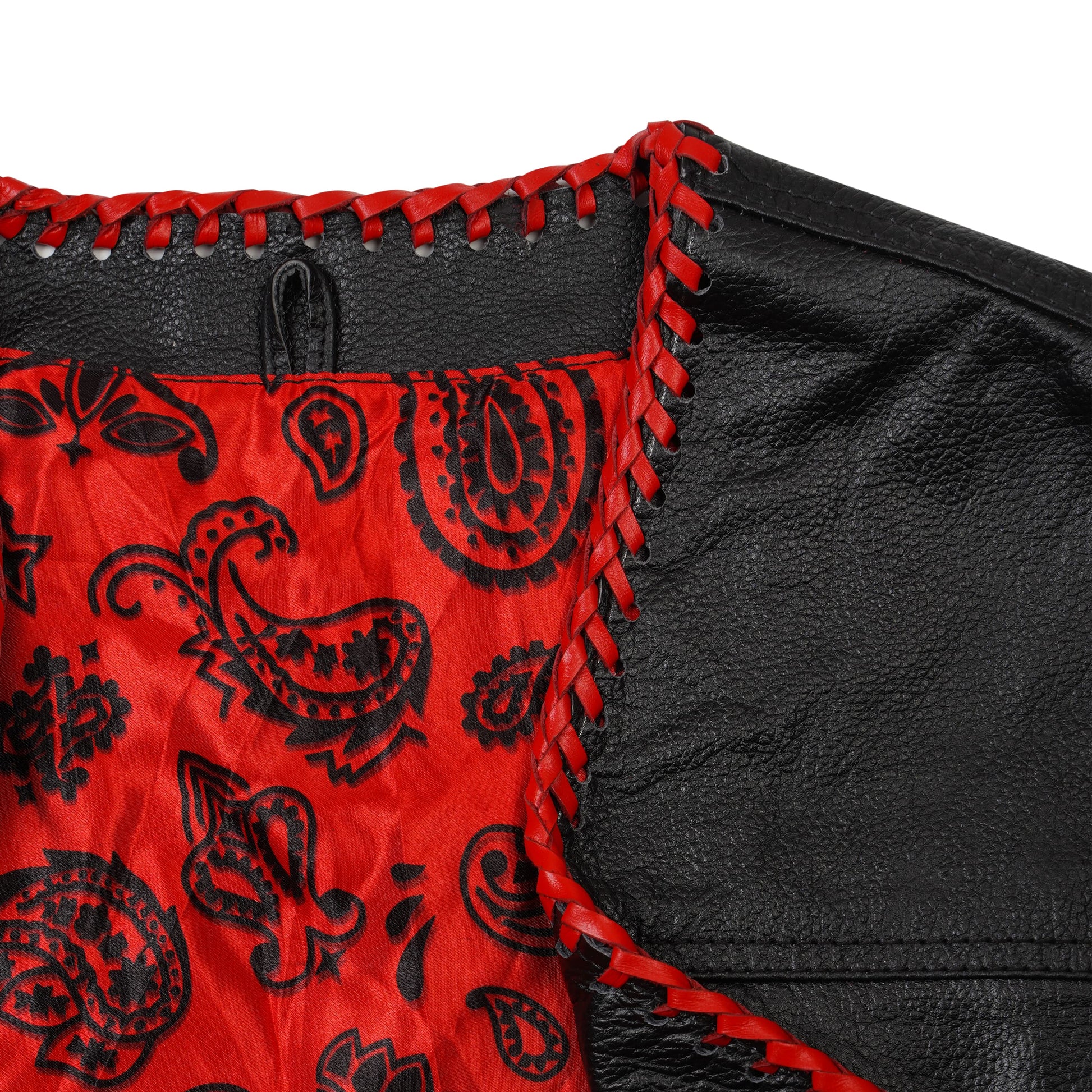 Detailed close-up image of buffalo leather custom red biker vest with ribbed paneling and satin lining. Handmade motorcycle vest with concealed carry option, functional waist and inner pockets, and customizable for MC patches and club logos. Perfect leather vest for motorcycle riders and biker club members.